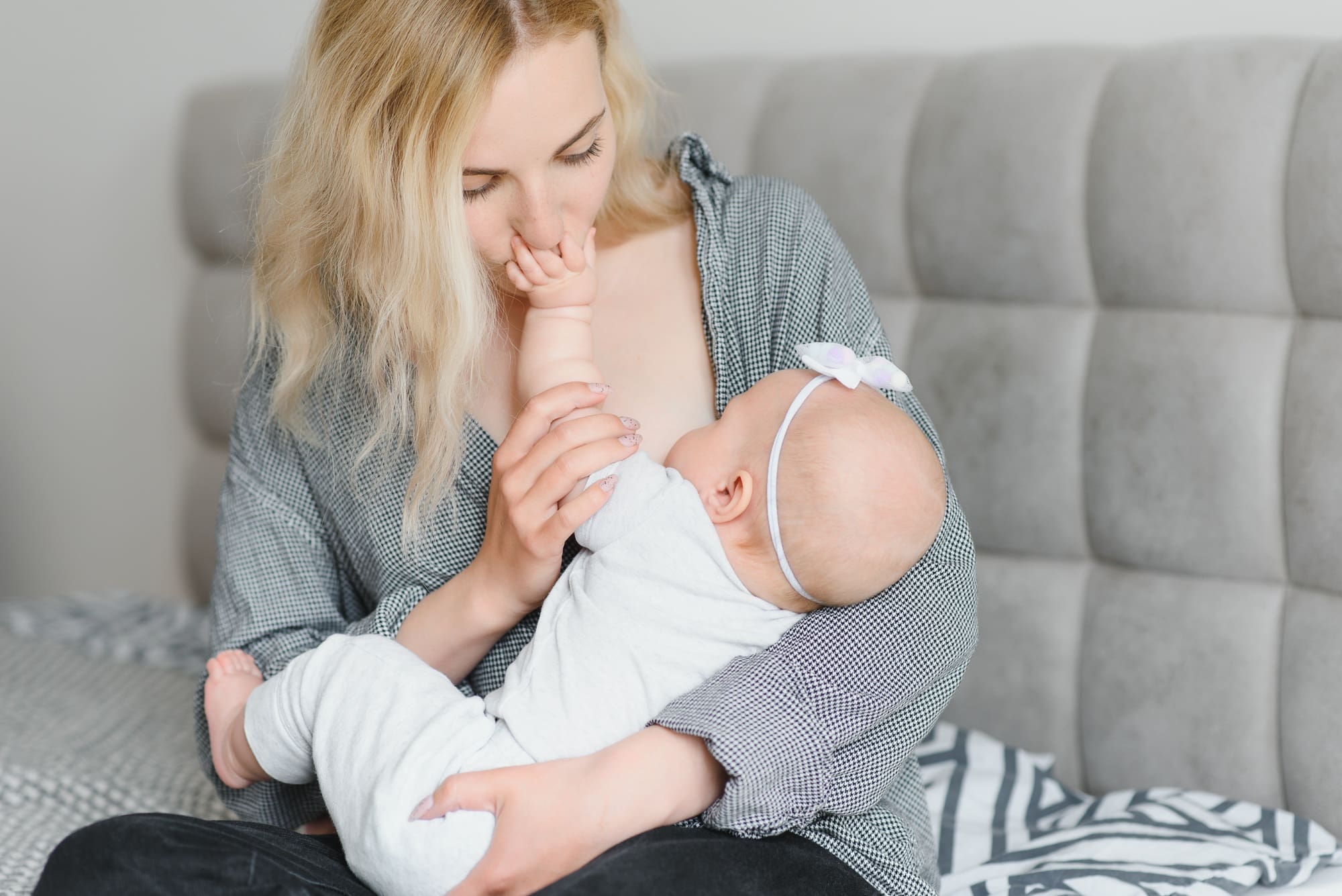 Lactation concept. Young mother breastfeeding her newborn baby at home, close up